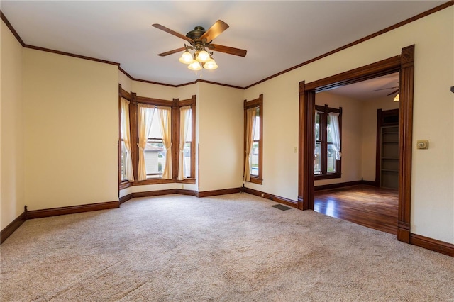 unfurnished room with carpet, crown molding, and ceiling fan