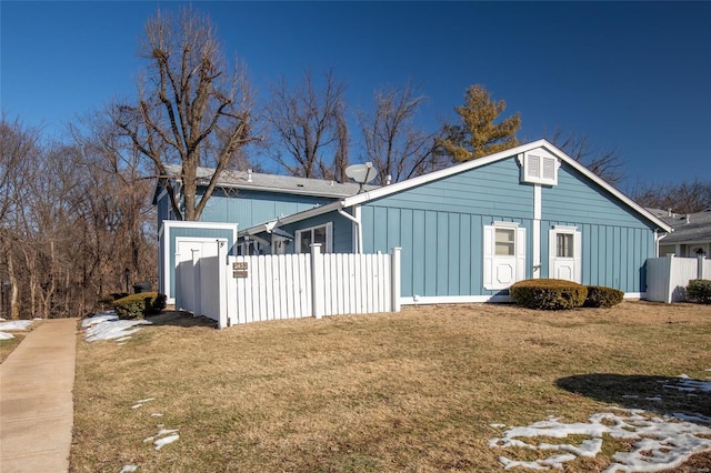 view of side of home featuring a yard