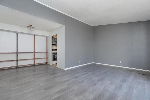 unfurnished living room featuring wood-type flooring and a textured ceiling