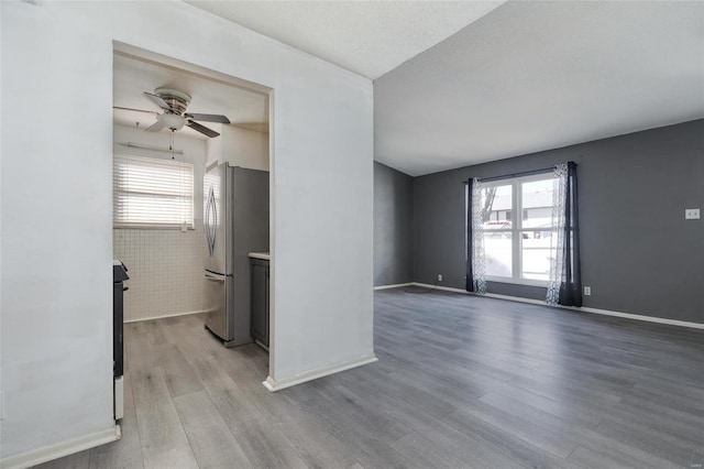 empty room featuring ceiling fan and light hardwood / wood-style flooring