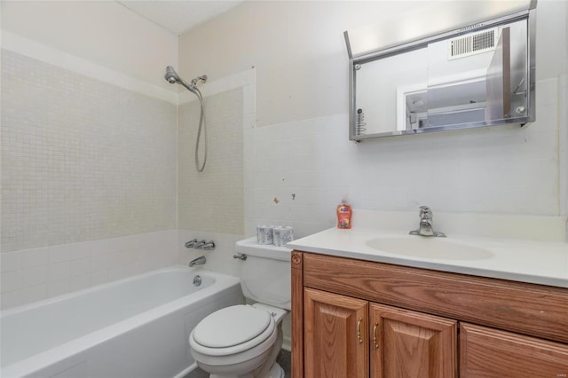 full bathroom with vanity, shower / washtub combination, tile walls, and toilet