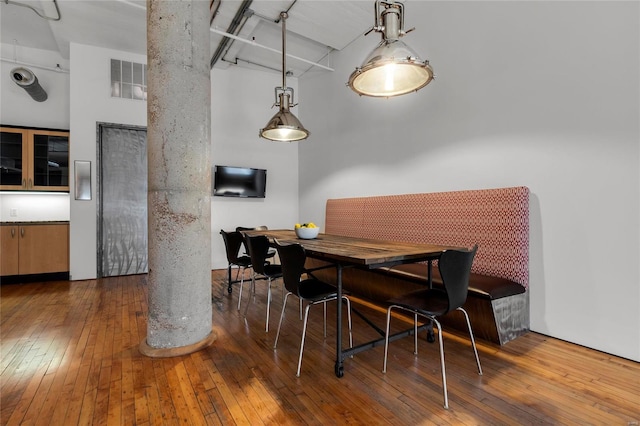 dining area with dark hardwood / wood-style flooring