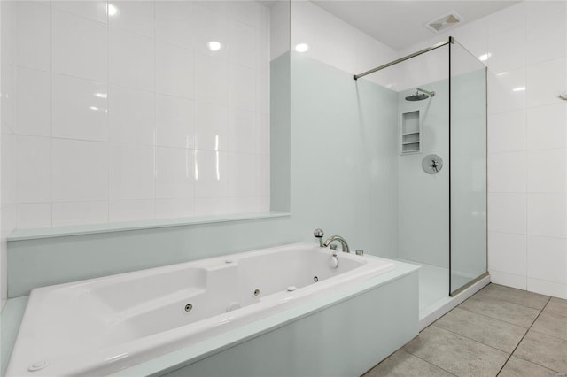 bathroom featuring tile patterned flooring and separate shower and tub