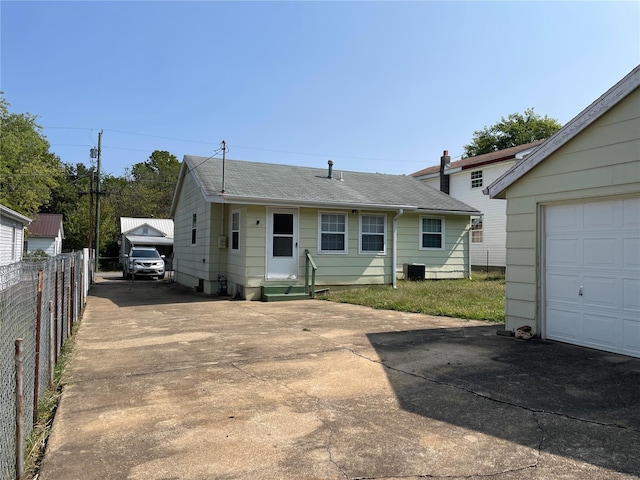 view of front of property with central AC unit and a garage