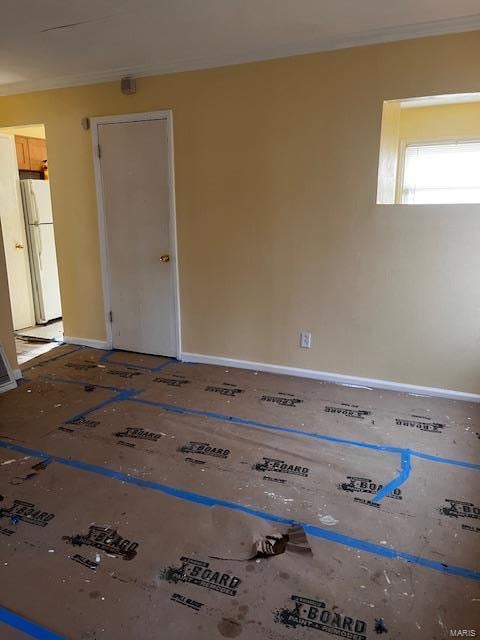 empty room featuring crown molding