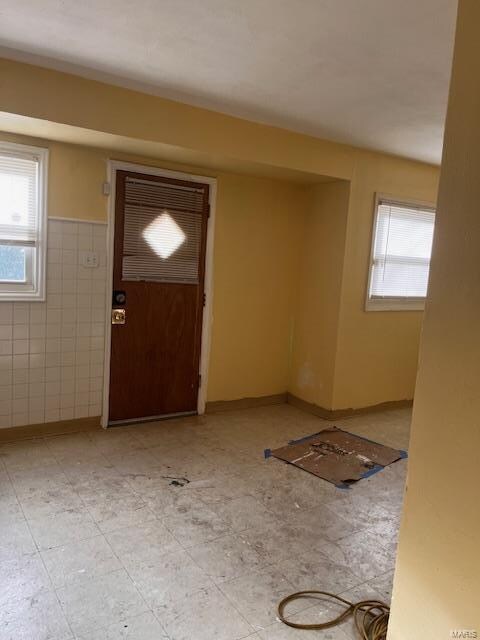 entryway featuring tile walls