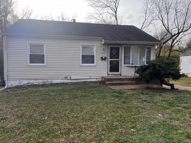 view of front of property with a sunroom and a front lawn