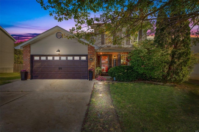 view of front of home featuring a garage and a yard