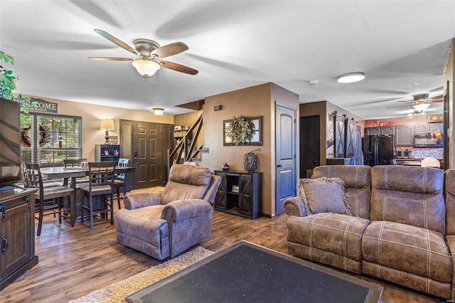 living room with hardwood / wood-style flooring and ceiling fan