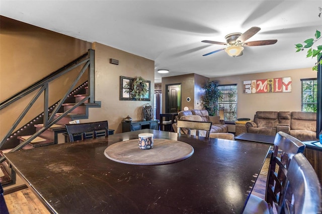 dining space featuring wood-type flooring, ceiling fan, and a healthy amount of sunlight