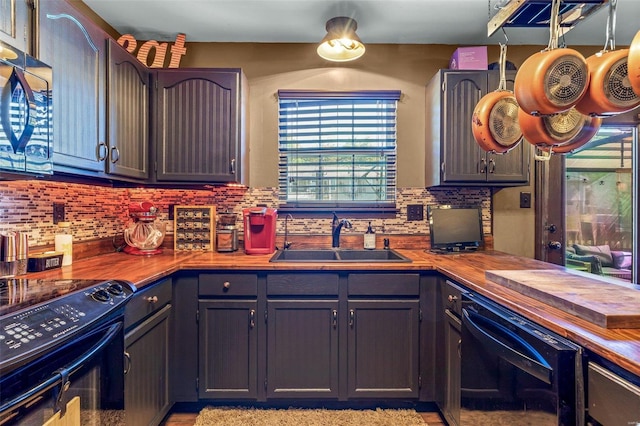 kitchen with tasteful backsplash, electric range, sink, and wooden counters