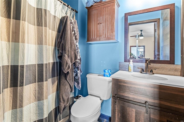 bathroom with ceiling fan, vanity, and toilet