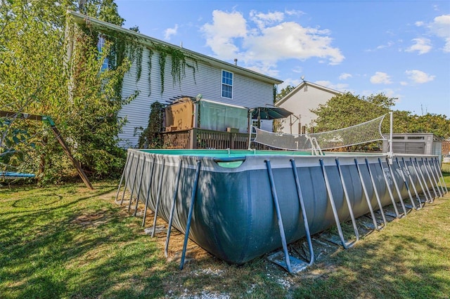 view of pool with a lawn