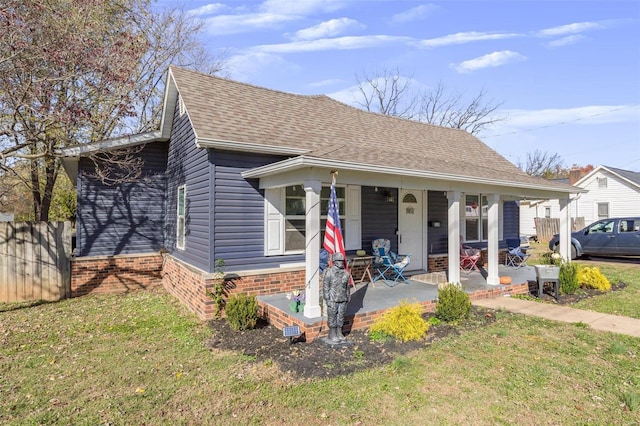 bungalow-style house with a porch and a front lawn