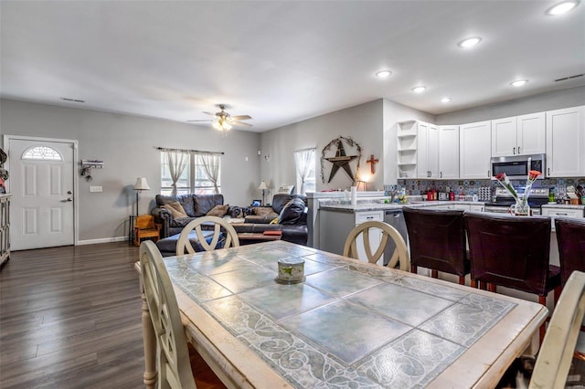 dining room featuring dark hardwood / wood-style flooring and ceiling fan