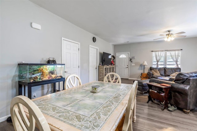 dining room with hardwood / wood-style flooring and ceiling fan