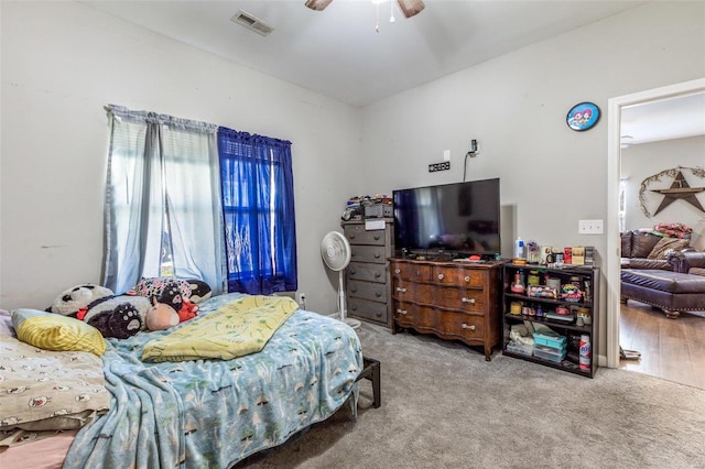 bedroom with hardwood / wood-style flooring and ceiling fan