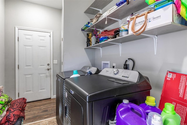 clothes washing area featuring hardwood / wood-style floors and independent washer and dryer