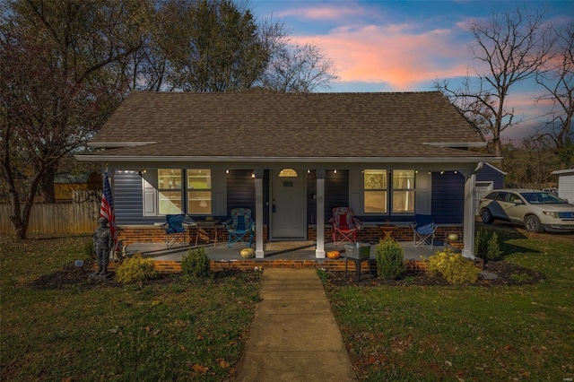 bungalow-style home featuring a yard and a porch