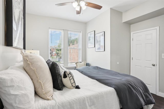 bedroom with ceiling fan and dark hardwood / wood-style floors