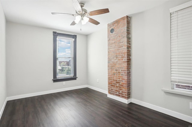 unfurnished room with dark wood-type flooring and ceiling fan