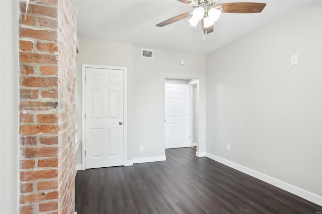 empty room featuring ceiling fan and dark hardwood / wood-style floors