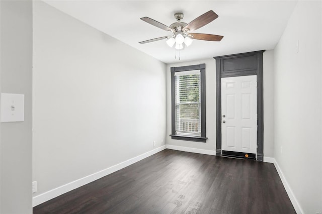 foyer entrance with ceiling fan and dark wood-type flooring