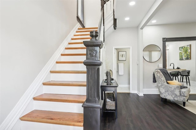 stairway featuring wood-type flooring