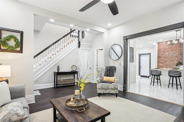 living room with ceiling fan and dark hardwood / wood-style flooring