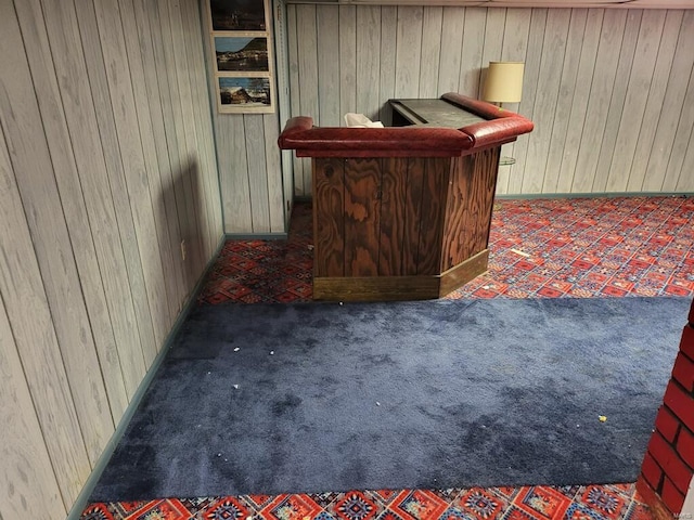 bar featuring dark colored carpet and wooden walls