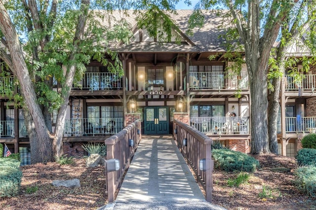 view of front facade with french doors and a balcony