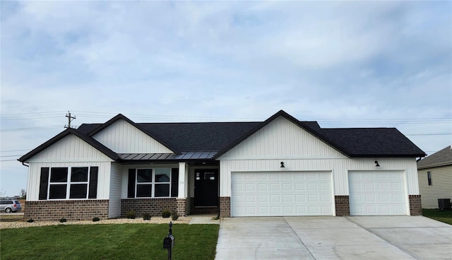 view of front of house featuring central AC unit, a garage, and a front lawn