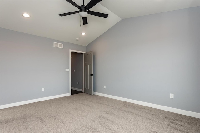 carpeted empty room featuring ceiling fan and lofted ceiling