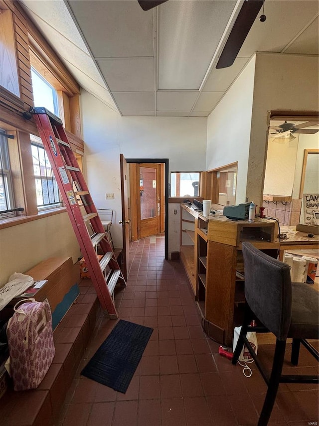 interior space with ceiling fan and a paneled ceiling