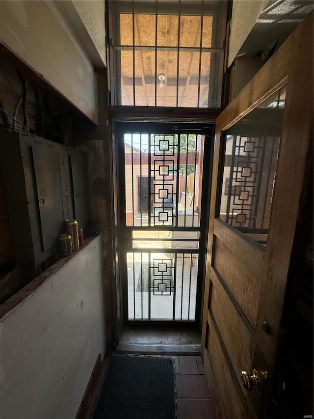 doorway to outside with tile patterned flooring