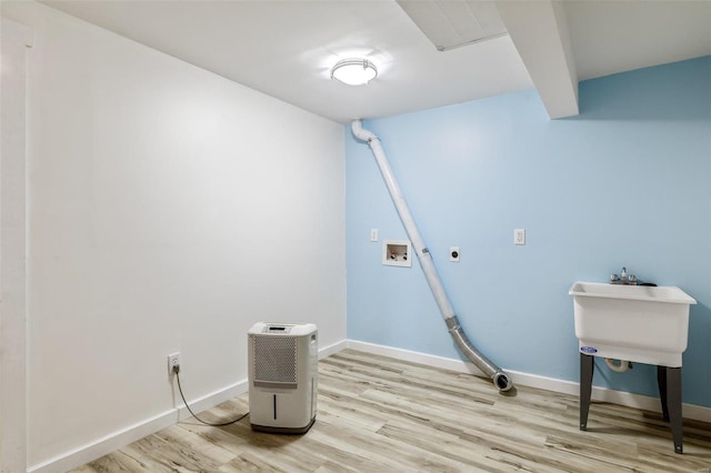 washroom with hookup for a washing machine, electric dryer hookup, and light hardwood / wood-style flooring