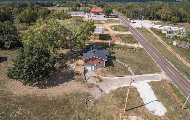 bird's eye view with a wooded view