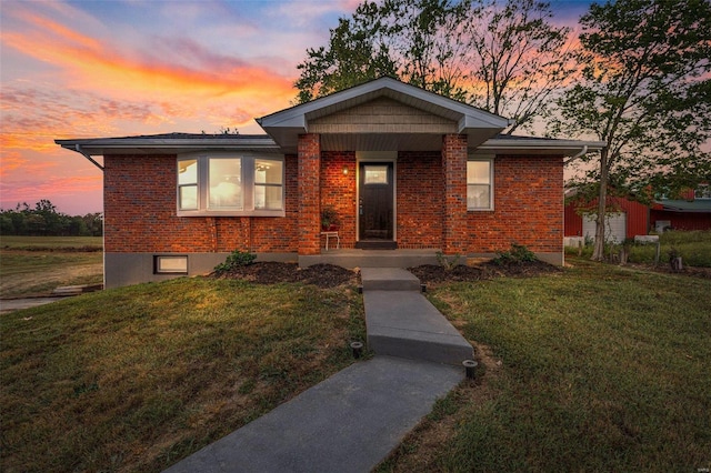 view of front of property with brick siding and a front lawn