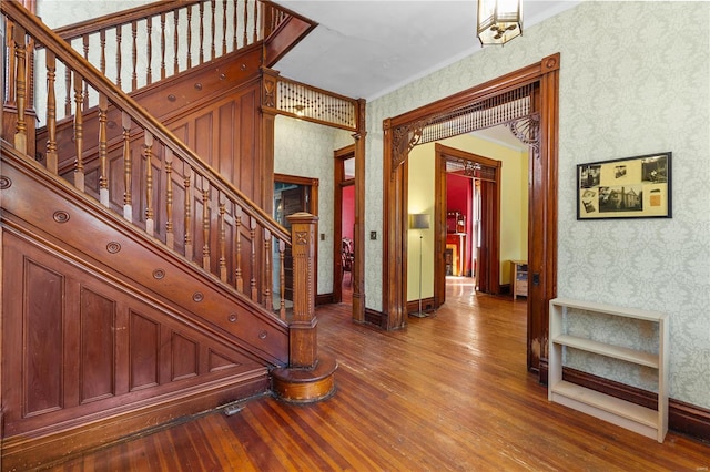 interior space featuring wood-type flooring and ornamental molding