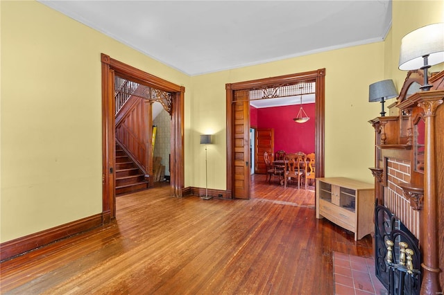 foyer entrance featuring dark hardwood / wood-style floors and crown molding