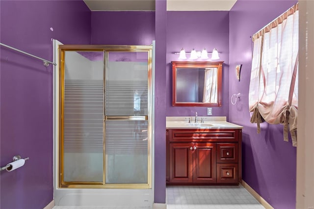 bathroom with a shower with door and vanity