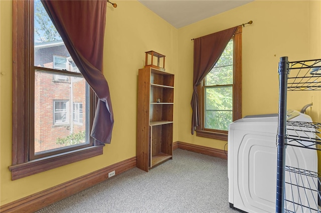 carpeted bedroom featuring washer / clothes dryer