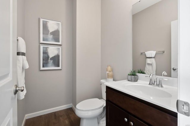 bathroom featuring hardwood / wood-style flooring, vanity, and toilet