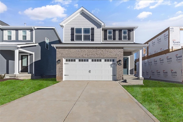 view of front of house with a garage and a front lawn