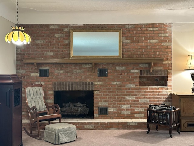 living room with a brick fireplace, carpet, and a textured ceiling