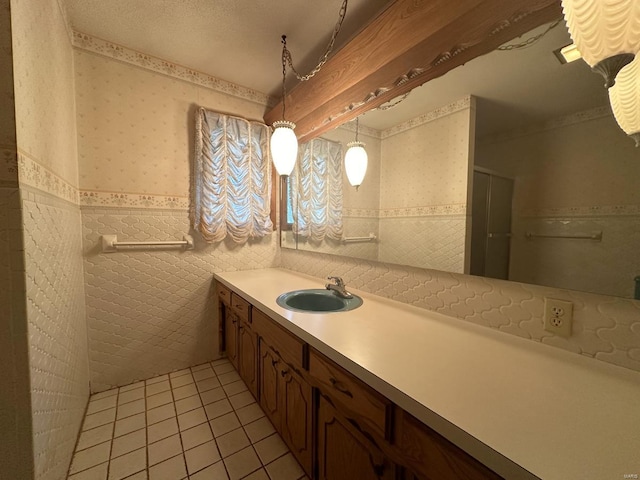 bathroom with tile walls, vanity, walk in shower, a textured ceiling, and tile patterned floors