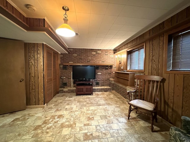 sitting room with wood walls and brick wall