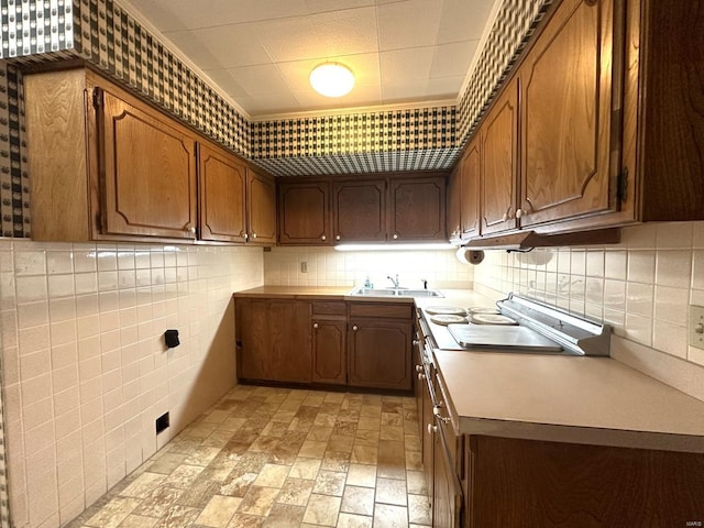 kitchen with tile walls, sink, and decorative backsplash