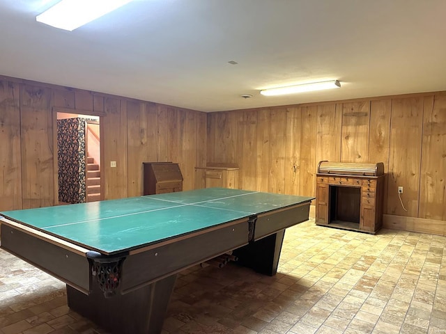 game room featuring wood walls