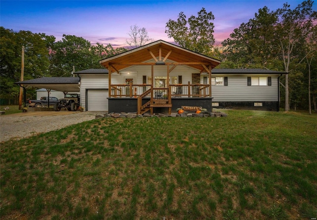 view of front of house featuring a carport, an outdoor structure, a deck, and a yard